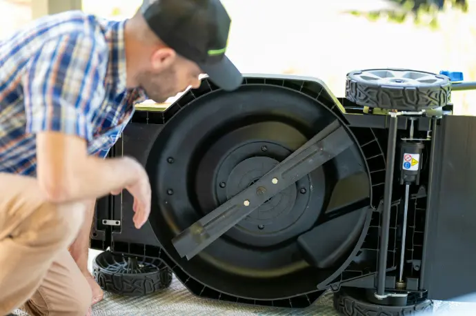 a man kneeling down next to a large machine
